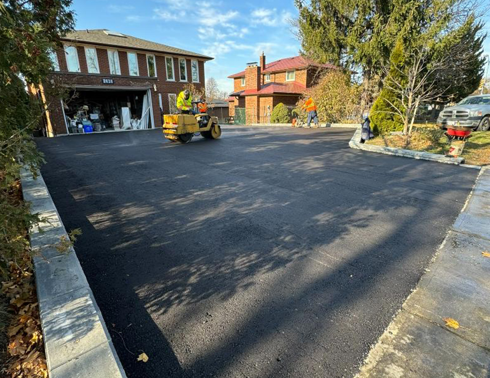 Asphalt driveway being rolled